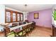 Bright dining room featuring a wooden table, detailed trim windows, and elegant chandelier at 66 N Ritter Ave, Indianapolis, IN 46219