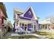 Charming purple two-story home with a quaint front porch and swing, creating an inviting curb appeal at 66 N Ritter Ave, Indianapolis, IN 46219