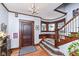 Inviting foyer features a charming staircase and dark wood trim at 66 N Ritter Ave, Indianapolis, IN 46219