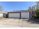 Two-car detached garage with white doors and purple siding, standing on a concrete pad at 66 N Ritter Ave, Indianapolis, IN 46219