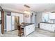 Modern kitchen with stainless steel appliances, white cabinets and black granite topped island at 66 N Ritter Ave, Indianapolis, IN 46219