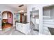 Bright kitchen with island, view to staircase and door, creating an open, welcoming space at 66 N Ritter Ave, Indianapolis, IN 46219