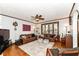 Spacious living room with hardwood floors, a ceiling fan, and plenty of natural light at 66 N Ritter Ave, Indianapolis, IN 46219