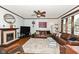 Cozy living room boasts a fireplace, large TV, and comfortable seating with hardwood floors at 66 N Ritter Ave, Indianapolis, IN 46219