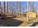 Home's spacious backyard features a large deck, shed, and mature trees in a private setting at 8349 Tequista Cir, Indianapolis, IN 46236
