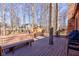 Expansive wooden deck offers multiple seating areas and views of the trees, shed, and backyard at 8349 Tequista Cir, Indianapolis, IN 46236