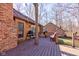 Backyard deck with seating and grill, perfect for outdoor entertaining by a brick home at 8349 Tequista Cir, Indianapolis, IN 46236