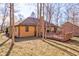 Home's backyard features a large wooden deck, trees, and well-maintained landscaping at 8349 Tequista Cir, Indianapolis, IN 46236
