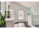 Elegant bathroom with dual vanities, sleek mirrors, and a glass-enclosed shower, complemented by black marble flooring at 8349 Tequista Cir, Indianapolis, IN 46236