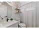 Bright bathroom features floral wallpaper, a modern vanity, and a shower with a decorative curtain at 8349 Tequista Cir, Indianapolis, IN 46236