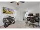 Spacious bedroom has neutral carpet, a ceiling fan, a TV, and a dedicated desk and workout space at 8349 Tequista Cir, Indianapolis, IN 46236