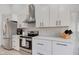 Contemporary kitchen with stainless steel appliances, white cabinets, and modern backsplash at 8349 Tequista Cir, Indianapolis, IN 46236