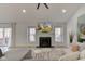 Cozy living room showcasing a fireplace, a large TV, and bright windows at 8349 Tequista Cir, Indianapolis, IN 46236