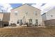 View of the backyard with a gravel area with outdoor seating, grill, and a grassy area at 9703 W Stargazer Dr, Pendleton, IN 46064