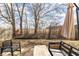 View of the backyard with a gravel area with outdoor seating, grill, and a grassy area at 9703 W Stargazer Dr, Pendleton, IN 46064