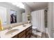 Clean bathroom featuring a double sink vanity, shower with curtain, and linen closet at 9703 W Stargazer Dr, Pendleton, IN 46064