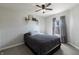 This bedroom features a cozy bed, soft carpet, neutral walls, and a ceiling fan with light fixture at 9703 W Stargazer Dr, Pendleton, IN 46064