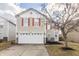 A cozy two story house showcasing a two car garage, red shutters, and stone veneer at 9703 W Stargazer Dr, Pendleton, IN 46064