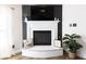 Close-up of the fireplace with a modern mantle, decor, and plants at 9703 W Stargazer Dr, Pendleton, IN 46064
