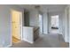 Upstairs hallway features neutral walls and flooring with doors leading to bedrooms and storage at 9703 W Stargazer Dr, Pendleton, IN 46064