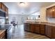 Modern kitchen with stainless steel appliances, wood cabinets, and an open layout to the dining area at 9703 W Stargazer Dr, Pendleton, IN 46064