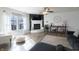 Cozy living room features a fireplace, neutral decor, and many windows at 9703 W Stargazer Dr, Pendleton, IN 46064