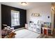 Open-concept living room featuring laminate flooring, a large window, and designer wall finishes at 9703 W Stargazer Dr, Pendleton, IN 46064