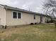 Expansive backyard featuring a well-maintained lawn, a small patio, mature trees, and durable siding at 971 Alexander St, Greenwood, IN 46143