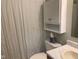 Bathroom with shower curtain, toilet, cabinet, countertop and sink at 971 Alexander St, Greenwood, IN 46143