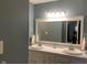 Bathroom with a large mirror, vanity, double sinks and modern lighting at 971 Alexander St, Greenwood, IN 46143