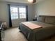 Bedroom with a bed, dresser, lamp, and large window to let in natural light at 971 Alexander St, Greenwood, IN 46143