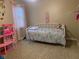 A bedroom featuring a white metal bed frame and a doll house at 971 Alexander St, Greenwood, IN 46143