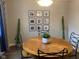 Bright dining room featuring a round wooden table with black chairs, modern light fixture, and framed photos at 971 Alexander St, Greenwood, IN 46143