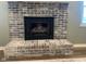 Close-up of the brick fireplace, with visible fire, in the living room, showcasing it's focal point at 971 Alexander St, Greenwood, IN 46143