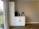 A coffee bar area with white cabinetry and a coffee maker next to a sliding glass door at 971 Alexander St, Greenwood, IN 46143