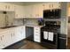 Well-lit kitchen features a stainless steel microwave, gas range, and ample counter space at 971 Alexander St, Greenwood, IN 46143