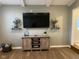 Stylish living room features modern media center, mounted TV, floating shelves, and sleek wooden floors at 971 Alexander St, Greenwood, IN 46143