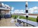 Covered back patio with seating and a charcoal grill, overlooking a spacious backyard at 1006 Cherry Tree Ln, Greenwood, IN 46143