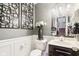 Stylish powder room with modern fixtures, decorative mirror, and elegant wall decor at 1006 Cherry Tree Ln, Greenwood, IN 46143