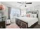 Elegantly decorated bedroom featuring a modern ceiling fan, plush rug, and decorative wall mirrors at 1006 Cherry Tree Ln, Greenwood, IN 46143