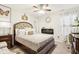 Cozy bedroom with decorative pillows and a statement crown above an upholstered headboard at 1006 Cherry Tree Ln, Greenwood, IN 46143