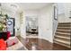 Welcoming foyer featuring hardwood floors, chandelier lighting, staircase, and glimpse of the formal dining room at 1006 Cherry Tree Ln, Greenwood, IN 46143