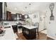 Stunning kitchen with dark wood cabinetry, marble countertops, and pendant lighting over a center island at 1006 Cherry Tree Ln, Greenwood, IN 46143