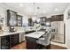 Charming kitchen featuring stainless steel appliances, dark wood cabinets, marble countertops, and pendant lighting at 1006 Cherry Tree Ln, Greenwood, IN 46143