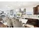 Bright kitchen with a center marble island, dark wood cabinetry, stainless appliances, and pendant lighting at 1006 Cherry Tree Ln, Greenwood, IN 46143