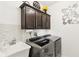 Organized laundry room featuring front-loading machines, upper cabinets, and a utility sink at 1006 Cherry Tree Ln, Greenwood, IN 46143