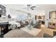 Bright living room featuring a fireplace, modern decor, large windows, and a view of the open-concept kitchen at 1006 Cherry Tree Ln, Greenwood, IN 46143