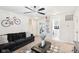 Comfortable living room with a black sofa, patterned rug, and ceiling fan with lighting at 1006 Cherry Tree Ln, Greenwood, IN 46143