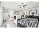 Spacious main bedroom featuring a tray ceiling, a fan with decorative lighting, and neutral-colored walls at 1006 Cherry Tree Ln, Greenwood, IN 46143