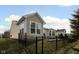 A beautiful fenced in backyard features a manicured lawn and a sunroom on the exterior of the home at 13998 Avalon Blvd, Fishers, IN 46037